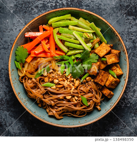 Soba noodles with vegetables and fried tofu in a bowl. Soba noodles with vegetables and fried tofu in a bowl. 138498350