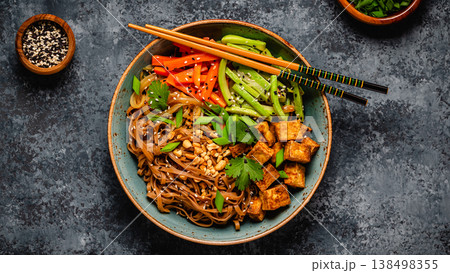 Soba noodles with vegetables and fried tofu in a bowl. Soba noodles with vegetables and fried tofu in a bowl. 138498355