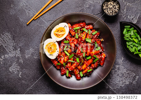 Tteokbokki, Teopokki fried rice cake in black bowl. Tteokbokki, Teopokki fried rice cake in black bowl. 138498372