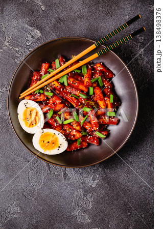 Tteokbokki, Teopokki fried rice cake in black bowl. 138498376