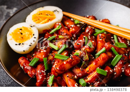 Tteokbokki, Teopokki fried rice cake in black bowl. Tteokbokki, Teopokki fried rice cake in black bowl. 138498378