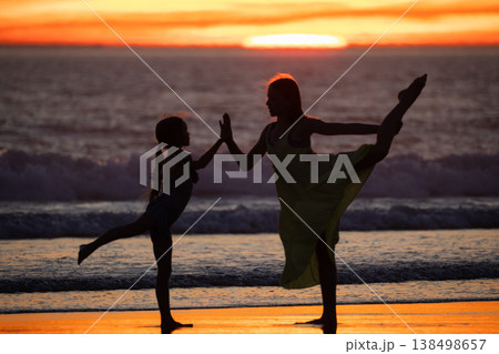 Girls practicing yoga dance on beach at sunset Girls practicing yoga dance on beach at sunset 138498657