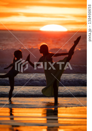 Mother and child balancing on sunset beach Mother and child balancing on sunset beach 138498658