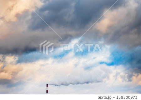 Environmental pollution, environmental issue, smoke coming from the chimney of an industrial plant or thermal power plant against the blue sky with clouds Environmental pollution, environmental issue, smoke coming from the chimney of an industrial plant or thermal power plant against the blue sky with clouds 138500973