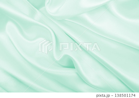 Smooth elegant green silk or satin luxury cloth texture as abstract background. Luxurious background design 138501174