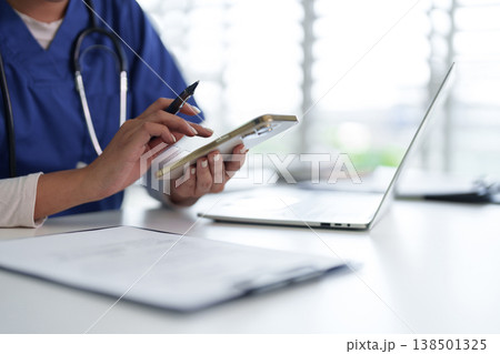 Healthcare professional adult hands using smartphone pen working on medical data hospital clinic office environment digital health technology Healthcare professional adult hands using smartphone pen working on medical data hospital clinic office environment digital health technology 138501325