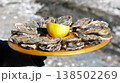 Close-up of 12 oysters on a tray with lemon fresh from the oyster farm 138502269