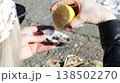 A close-up of a girl squeezing lemon onto a fresh oyster 138502270