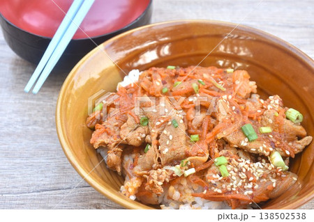fried slice fermenting pork meat with spicy Japanese sauce topping white sesame and pickled ginger on plain rice in bowl fried slice fermenting pork meat with spicy Japanese sauce topping white sesame and pickled ginger on plain rice in bowl 138502538