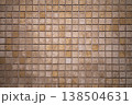 Stone mosaic tiles creating a uniform wall pattern, showing variations in natural material and subtle color tones, ideal for architectural and decorative backdrop designs 138504631