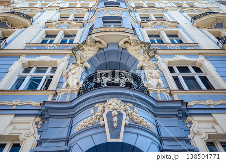 Ornate blue baroque facade with cherubs and balcony 138504771