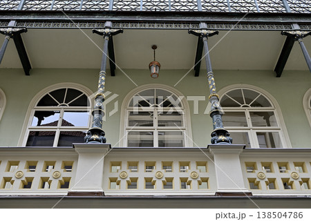 Colonial balcony facade with arched windows and iron columns Colonial balcony facade with arched windows and iron columns 138504786