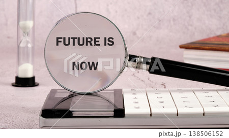 A desk scene captures a magnifying glass emphasizing FUTURE IS NOW, flanked by an hourglass, a calculator, and stacked books. It signals urgent progress 138506152