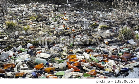 Dirty river is polluted with many plastic bottles. A lot of trash is dumped in open and freely available places at nature. Global environmental pollution problem. Concept of ecological disaster Dirty river is polluted with many plastic bottles. A lot of trash is dumped in open and freely available places at nature. Global environmental pollution problem. Concept of ecological disaster 138506357