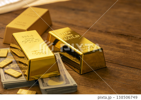 Stacked Gold Bullion Bars with Paper Currency on Wood - Financial Wealth and Investment Portfolio Display Stacked Gold Bullion Bars with Paper Currency on Wood - Financial Wealth and Investment Portfolio Display 138506749