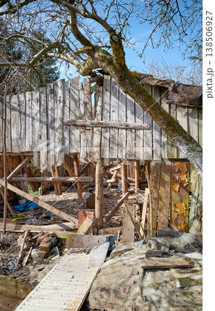 Demolition of an old wooden shed in the garden. Demolition of an old wooden shed in the garden. 138506927