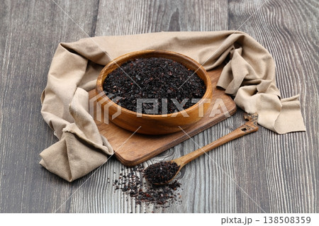 Dried Isot Pepper Flakes in a Wooden Bowl on Dark Wood Background - Traditional Turkish Urfa Chili Dried Isot Pepper Flakes in a Wooden Bowl on Dark Wood Background - Traditional Turkish Urfa Chili 138508359