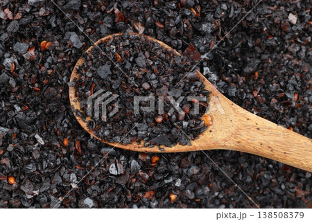 Macro Shot of Dried Isot Pepper Flakes in a Wooden Spoon Isolated on White Background - Turkish Chili Macro Shot of Dried Isot Pepper Flakes in a Wooden Spoon Isolated on White Background - Turkish Chili 138508379