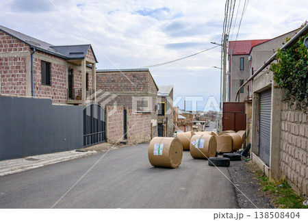Small street in village with stone houses and farm hay bales 138508404