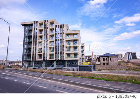 High-rise residential tower with minimalist design under sunny skies 138508446