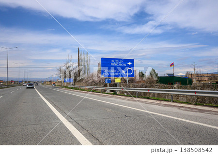 Highway scene with Hebrew road sign under clouded sky 138508542