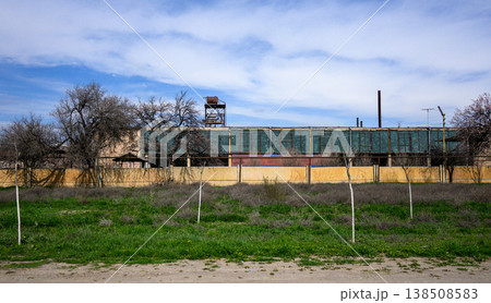 Abandoned factory structure under cloudy sky 138508583