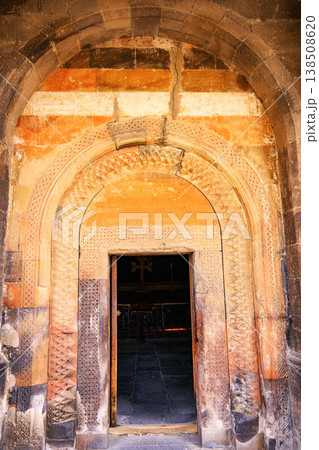 Old church entrance with textured brick walls and decorative archway Old church entrance with textured brick walls and decorative archway 138508620