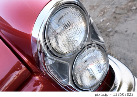 Vintage car headlight close-up on red classic automobile Vintage car headlight close-up on red classic automobile 138508822