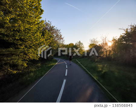 Athlete running on a road at sunset in prague Athlete running on a road at sunset in prague 138508843