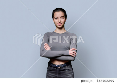 Portrait of beautiful young woman, 18-19 years old on gray background Portrait of beautiful young woman, 18-19 years old on gray background 138508895