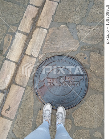 Top view of a tourist manhole with the inscription "Derbent", Dagestan, Russia. Urban detail featuring historical city name on street infrastructure 138508918