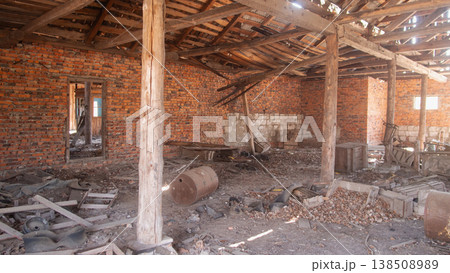 Sunlit Brick Warehouse Interior With Barrels, Exposed Wooden Columns And Broken Roof Beams, Scattered Rubble And Dust, Warm Shafts Of Light Highlighting Textured Mortar And Weathered Timber, 138508989