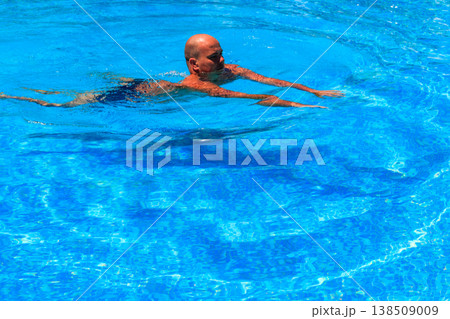 Handsome man relaxing in the swimming pool Handsome man relaxing in the swimming pool 138509009