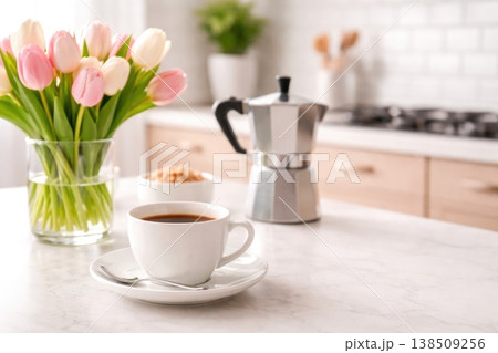 Coffee cup with tulips and moka pot in cozy kitchen interior soft light 138509256