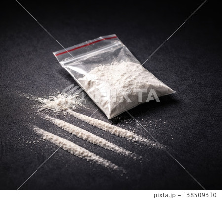White powder substance in plastic bag with lines on dark surface concept image White powder substance in plastic bag with lines on dark surface concept image 138509310