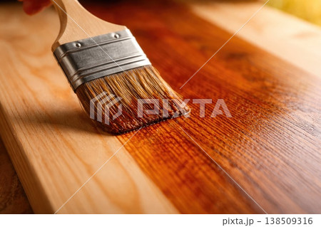 Wood surface staining with brush applying protective finish on natural timber Wood surface staining with brush applying protective finish on natural timber 138509316