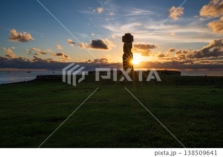 Majestic silhouette of mysterious moai statue on easter island rapa nui during peaceful sunset over ocean with radiant sunburst shining behind ancient stone monument Majestic silhouette of mysterious moai statue on easter island rapa nui during peaceful sunset over ocean with radiant sunburst shining behind ancient stone monument 138509641