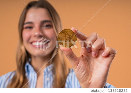 Pretty Woman With Bitcoin, Crypto Currency. Golden Coin On Beige Background. Pretty Woman With Bitcoin, Crypto Currency. Golden Coin On Beige Background. 138510285