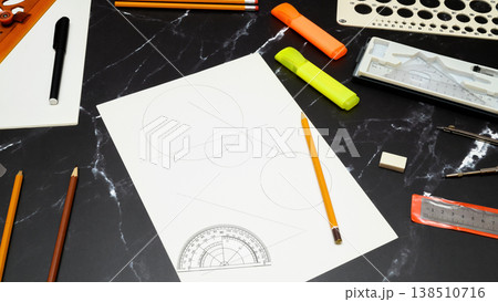 geometric sketch surrounded by drafting instruments 138510716