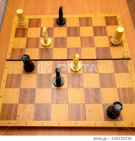 chess pieces on a large wooden board top view at a right angle 138510730