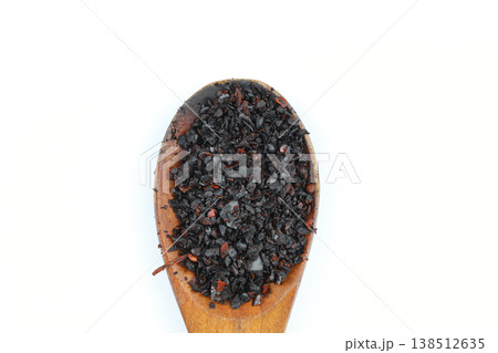 Macro Shot of Dried Isot Pepper Flakes in a Wooden Spoon Isolated on White Background - Turkish Chili 138512635