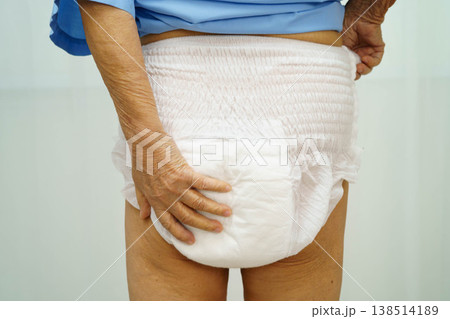 Asian senior woman patient wearing adult incontinence diaper pad in hospital. 138514189