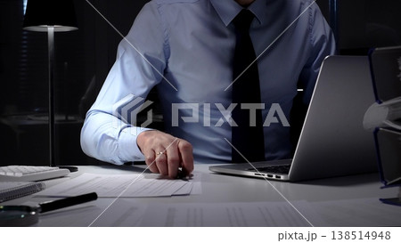 Businessman working late at night, typing on laptop, meeting deadlines and managing corporate finance administration. Audit and taxes in business Businessman working late at night, typing on laptop, meeting deadlines and managing corporate finance administration. Audit and taxes in business 138514948