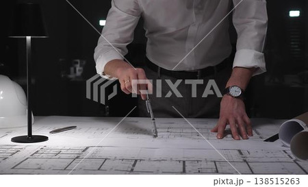 Architect designing building plans at night, working overtime on a new construction project with tools and blueprints. Architect designing building plans at night, working overtime on a new construction project with tools and blueprints. 138515263