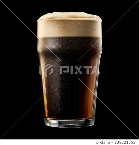 Foamy dark stout beer in a pint glass with creamy foam head, isolated on black background, concept of refreshment and taste Foamy dark stout beer in a pint glass with creamy foam head, isolated on black background, concept of refreshment and taste 138521353
