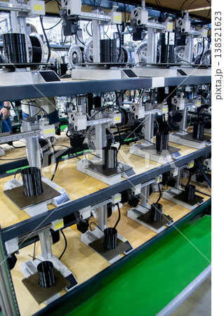 Many 3D printers printing object. 3D printers creating shape from molten plastic flowing out of extruder. 3D printer close up. Working 3D printer in process printing object from molten black plastic 138521623