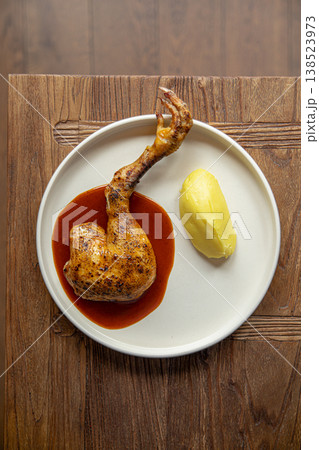 Roasted chicken leg with sauce and puree 138523973