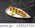 Sushi rolls wrapped in cucumber with spicy topping 138525704