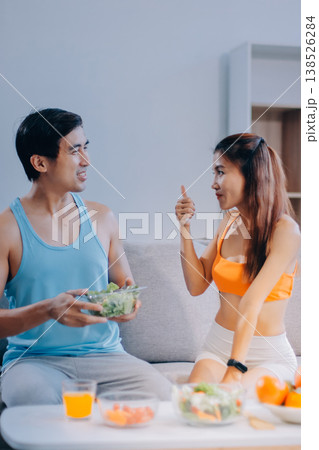A happy couple prepares fresh vegetables, laughing and enjoying cooking a healthy meal together. A happy couple prepares fresh vegetables, laughing and enjoying cooking a healthy meal together. 138526284