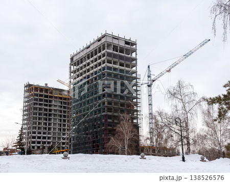 Construction of a building at Sakharov Square on the site of former Ferris wheel covered in snow cold early spring cityscape urban environment. Construction of a building at Sakharov Square on the site of former Ferris wheel covered in snow cold early spring cityscape urban environment. 138526576